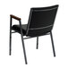 A black Flash Furniture Hercules stack chair with black vinyl and wooden armrests.