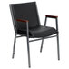 A black Flash Furniture Hercules stack chair with armrests.