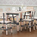 A Lancaster Table & Seating live edge wood table with chairs and glasses on it.