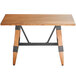 A Lancaster Table & Seating solid wood live edge dining table with legs.