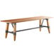 A Lancaster Table & Seating solid wood live edge dining table with legs.