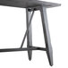 A Lancaster Table & Seating bar height table with live edge and slate gray finish and metal trestle legs.