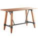 A Lancaster Table & Seating bar height trestle table with a wooden top and legs.