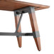 A Lancaster Table & Seating solid wood table with metal trestle legs.