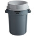 A grey Rubbermaid trash can with a white funnel top lid.