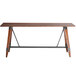 A Lancaster Table & Seating wooden table with live edges and metal legs.