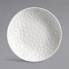 A white porcelain Reserve by Libbey deep coupe plate with a textured triangle pattern on the surface.