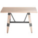 A Lancaster Table & Seating solid wood dining table with trestle legs.
