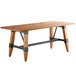 A Lancaster Table & Seating solid wood dining table with metal trestle legs.
