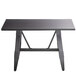 A black rectangular Lancaster Table & Seating live edge dining table with legs.