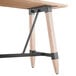A Lancaster Table & Seating bar height wooden table with metal legs.