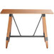 A Lancaster Table & Seating solid wood bar height table with wooden legs.