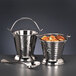 Two Libbey hammered stainless steel pails with spoons on a table.