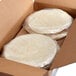 A white cardboard box filled with Mission pressed flour tortillas wrapped in plastic.