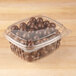 A Genpak clear plastic deli container filled with chocolate candies.