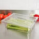 A Cambro clear plastic colander pan with celery inside.