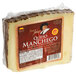 A Don Juan Manchego cheese wedge wrapped in plastic.