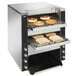 A Vollrath dual conveyor toaster with bread in it.