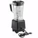 A Waring commercial blender with a black base and a cord attached.