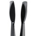 A close-up of a pair of black plastic tongs with easy-grasp handles.