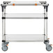 A Metro stainless steel three tiered cart with cutting board and stainless steel shelves.