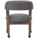 A Boss slate gray linen captain's chair with wheels.