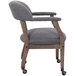 A Boss slate gray linen Captain's chair with wheels.