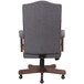 The back of a Boss slate gray linen executive chair with driftwood frame.