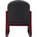 The back of a Boss black fabric side chair with mahogany wood frame.