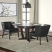 A black Boss Ava accent chair next to a table.
