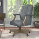 A Boss medium gray linen office chair with a driftwood base.