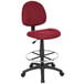 A Boss Burgundy drafting stool with a metal base.