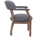 A Boss slate gray linen captain's chair with a wooden frame and armrests.