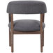 A Boss slate gray linen captain's chair with wooden legs.
