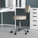 A Boss beige medical office stool with a curved back.