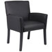 A Boss black leather executive box arm chair with black wooden legs.