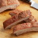 Sliced pork ribs on a cutting board with Regal Sweet Meat Rib Rub.