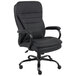 A black Boss office chair with arms and wheels.