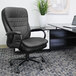 A black Boss office chair with a black leather seat next to a desk.