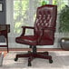 A Boss oxblood leather office chair with a mahogany finish.