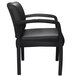 A black Boss guest chair with armrests and black leather seat.