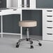A beige Boss Office adjustable stool with a round seat.