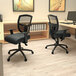 A black Boss Contract mesh office chair in front of a desk.