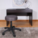 A Boss gray mesh office stool on a rug.