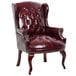 A Boss burgundy leather wingback chair with gold studs.