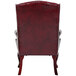 A Boss burgundy leather wingback guest chair with a backrest.