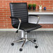 A black vinyl Boss office chair with chrome armrests.
