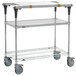 A silver and galvanized metal Metro PrepMate cart with wheels and a shelf.