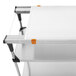A white Metro PrepMate MultiStation with a stainless steel shelf and orange cutting board.