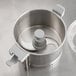 AvaMix Revolution stainless steel food processor with lid on a metal container.